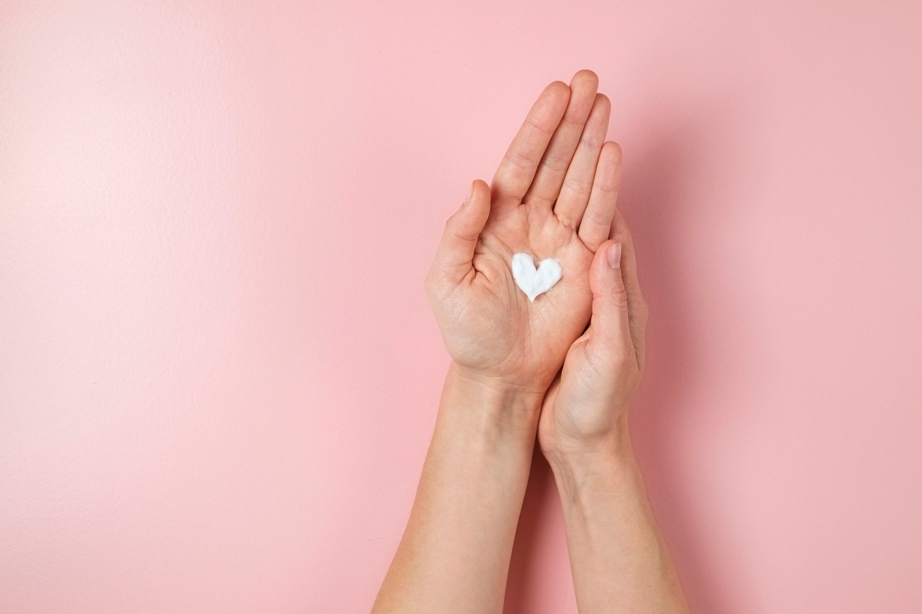 Female's hands applying skincare product
